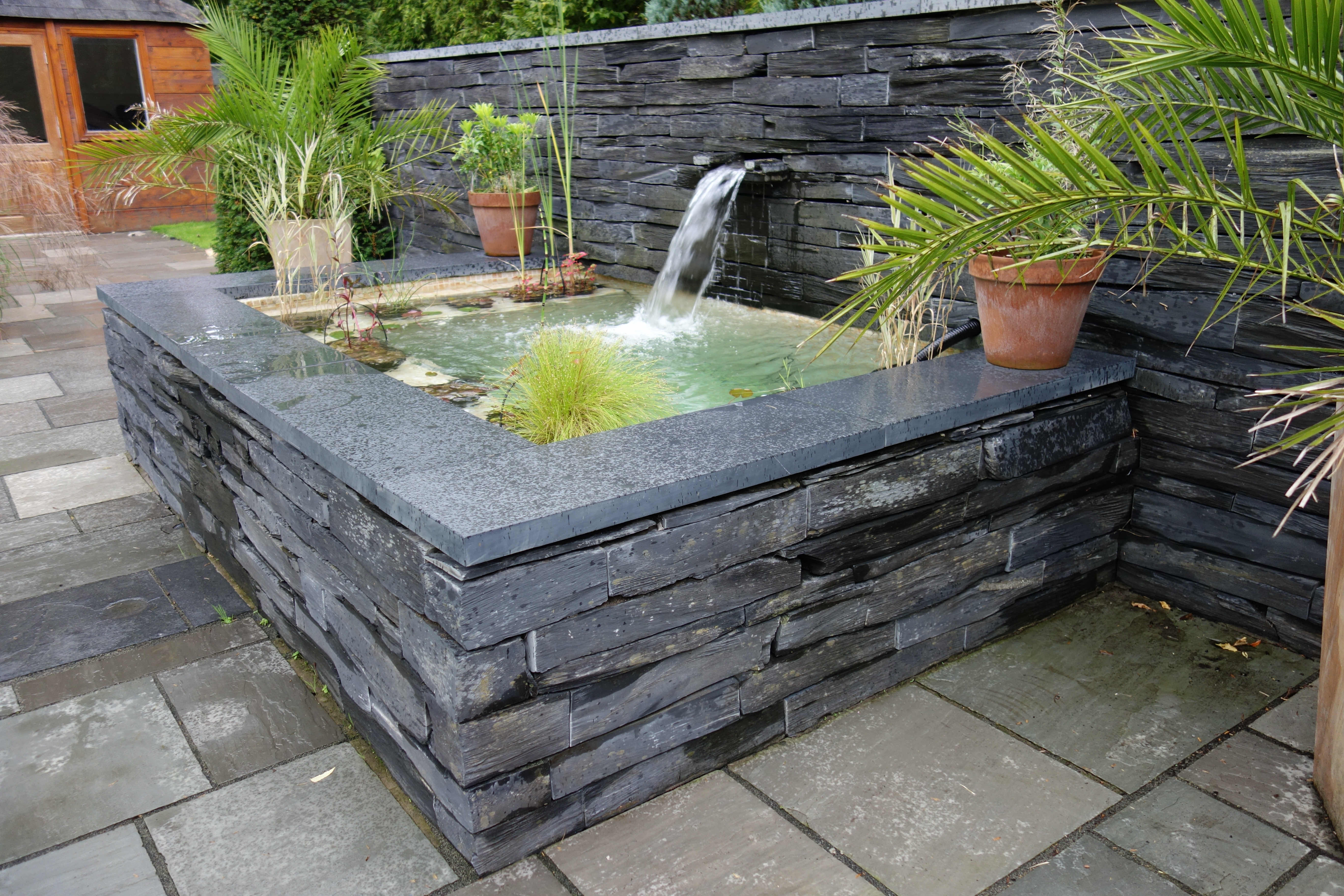 Raised slate pond with waterfall in Worsley, Manchester.