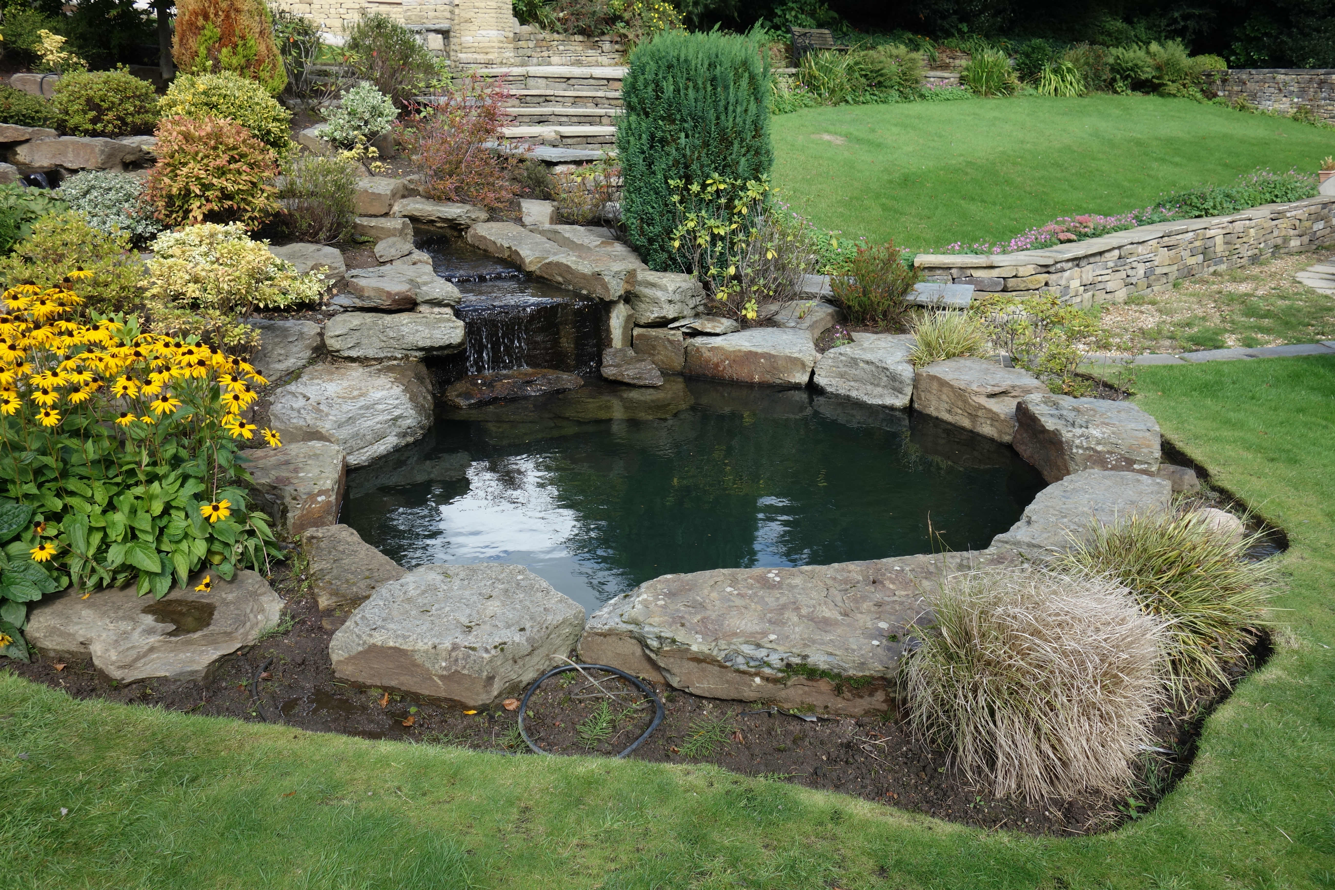 Circular pond fed by long winding stream in Bolton.